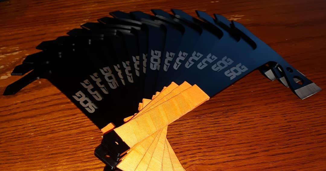 Stack of axe targets and throwing blades on wooden table, gear