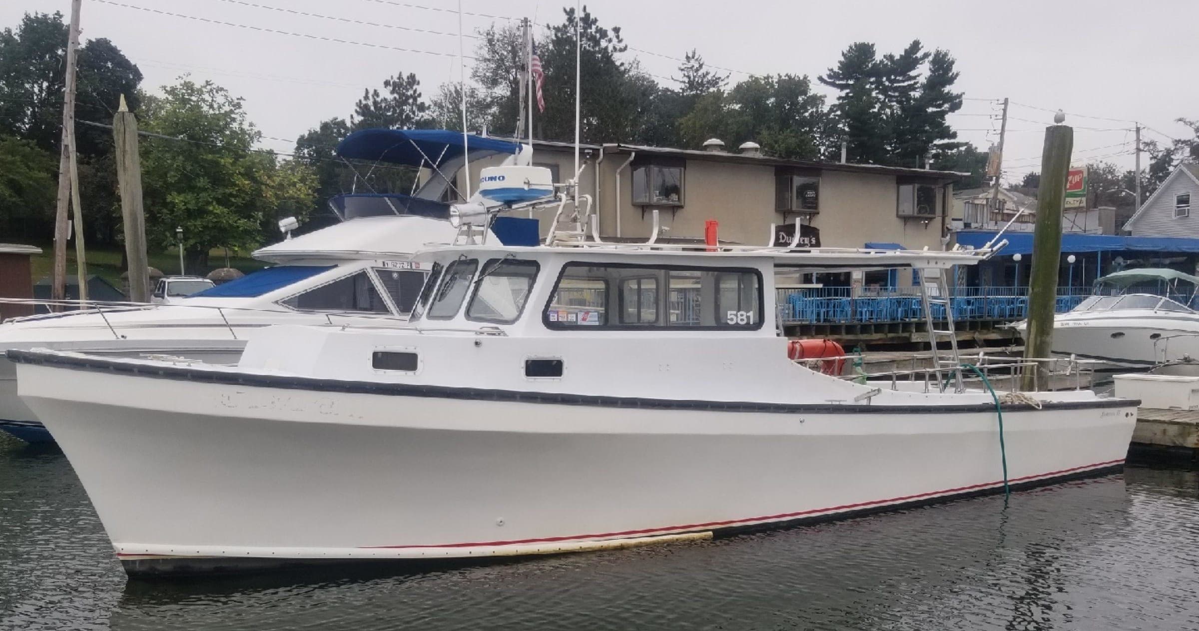 Private charter boat moored in marina on calm coastal harbor