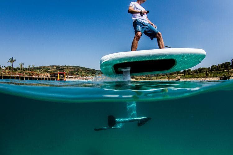 Half-submerged e-foil view showing foil and rider in clear water