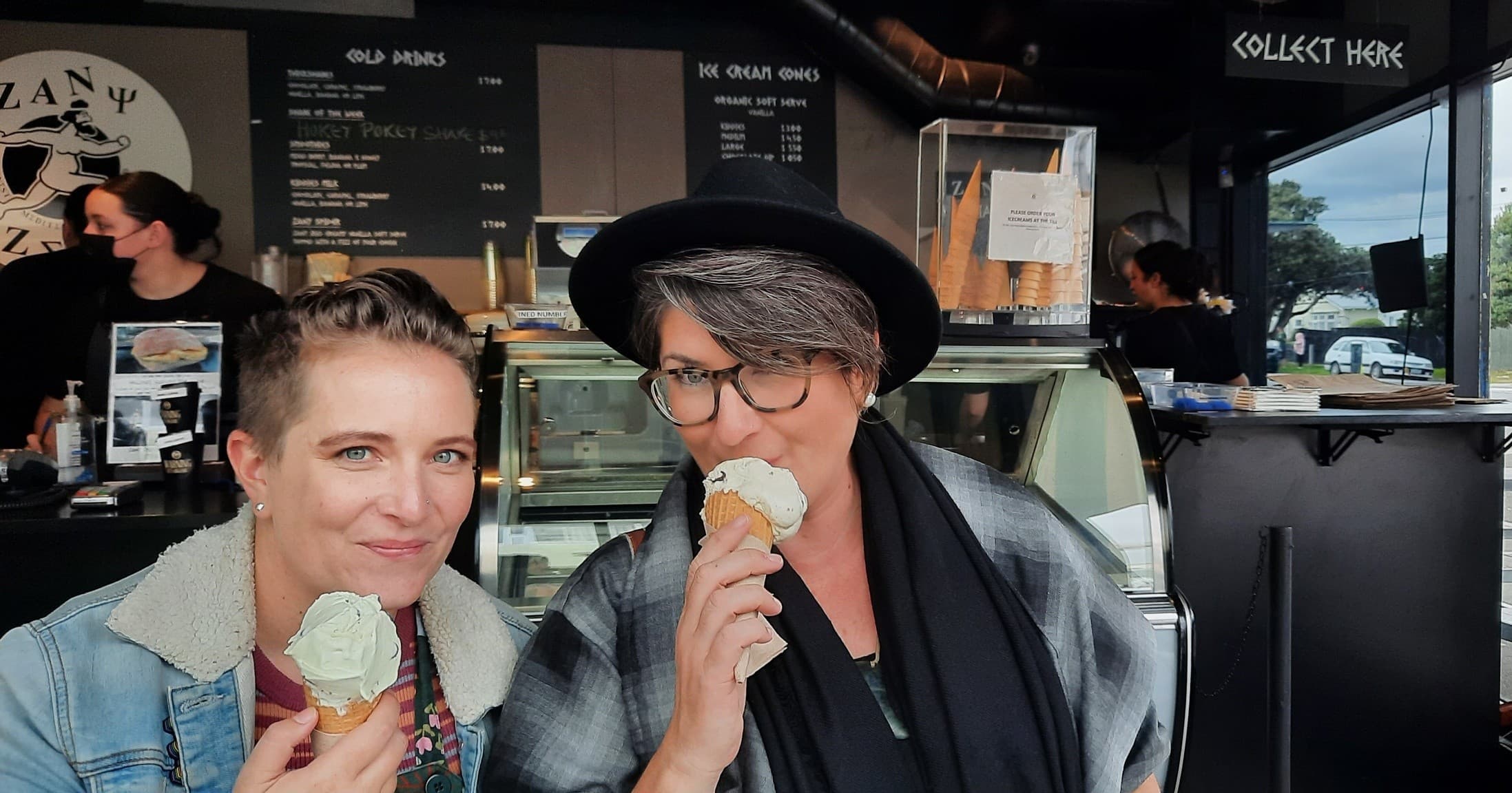 Friends enjoying ice cream cones at local cafe