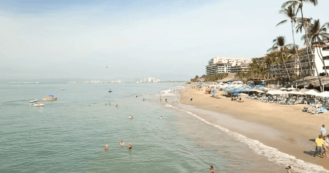 Swimmers and sandy beach along Puerto Vallarta coastline