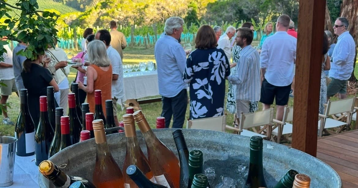 Outdoor wine tasting and social gathering on deck with vineyard views