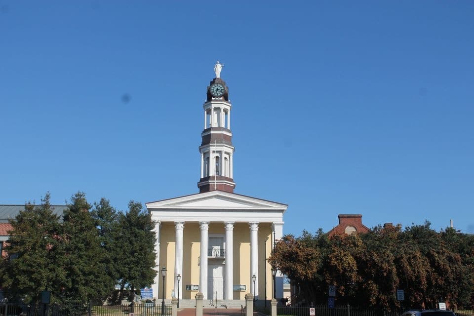 Historic church with steeple and lawn, guided walking tour