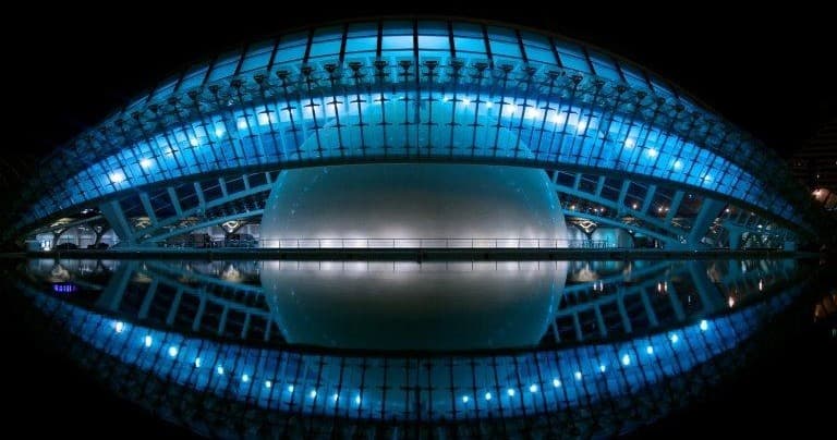 Illuminated modern architecture at night, dramatic waterfront view