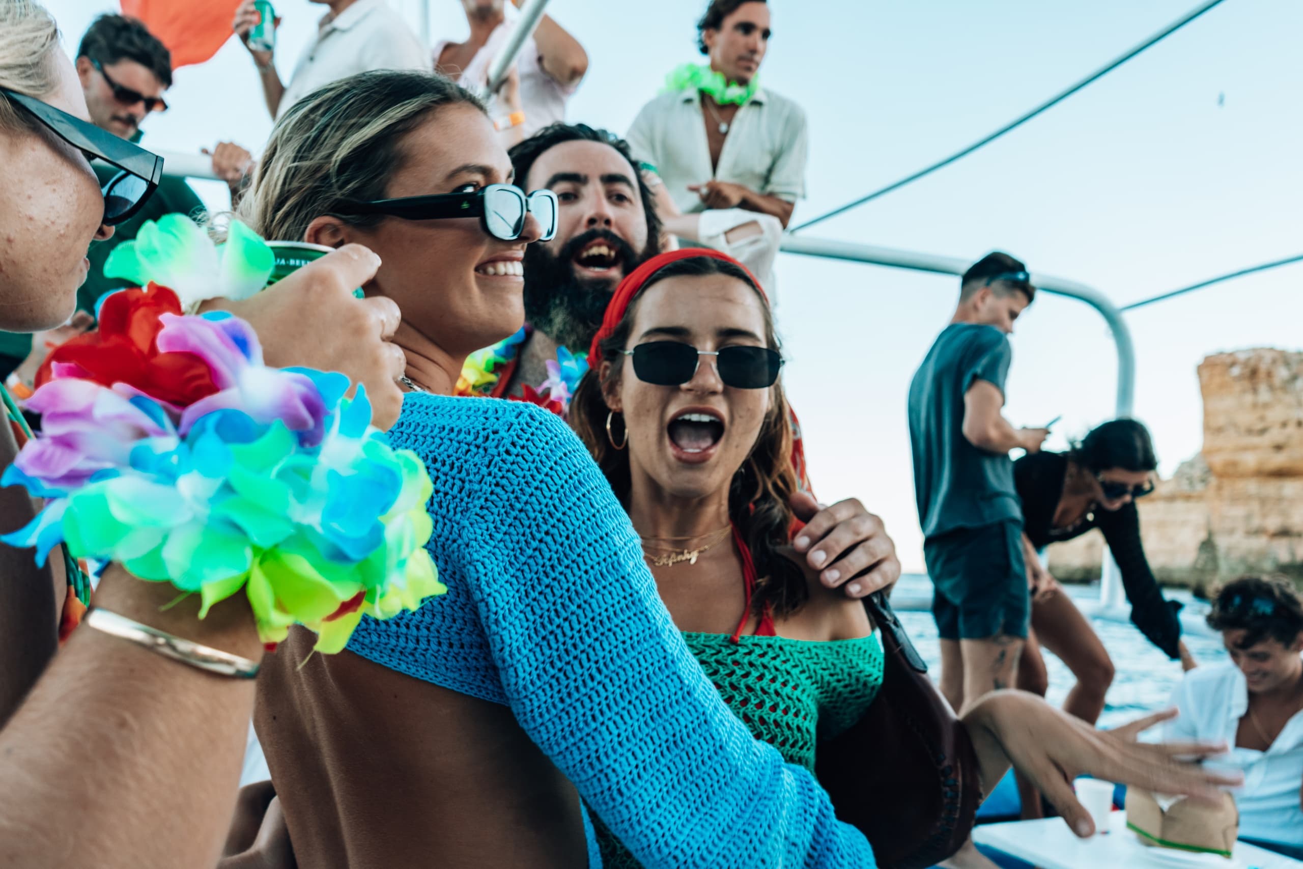 People partying on a sunny boat cruise with festive atmosphere