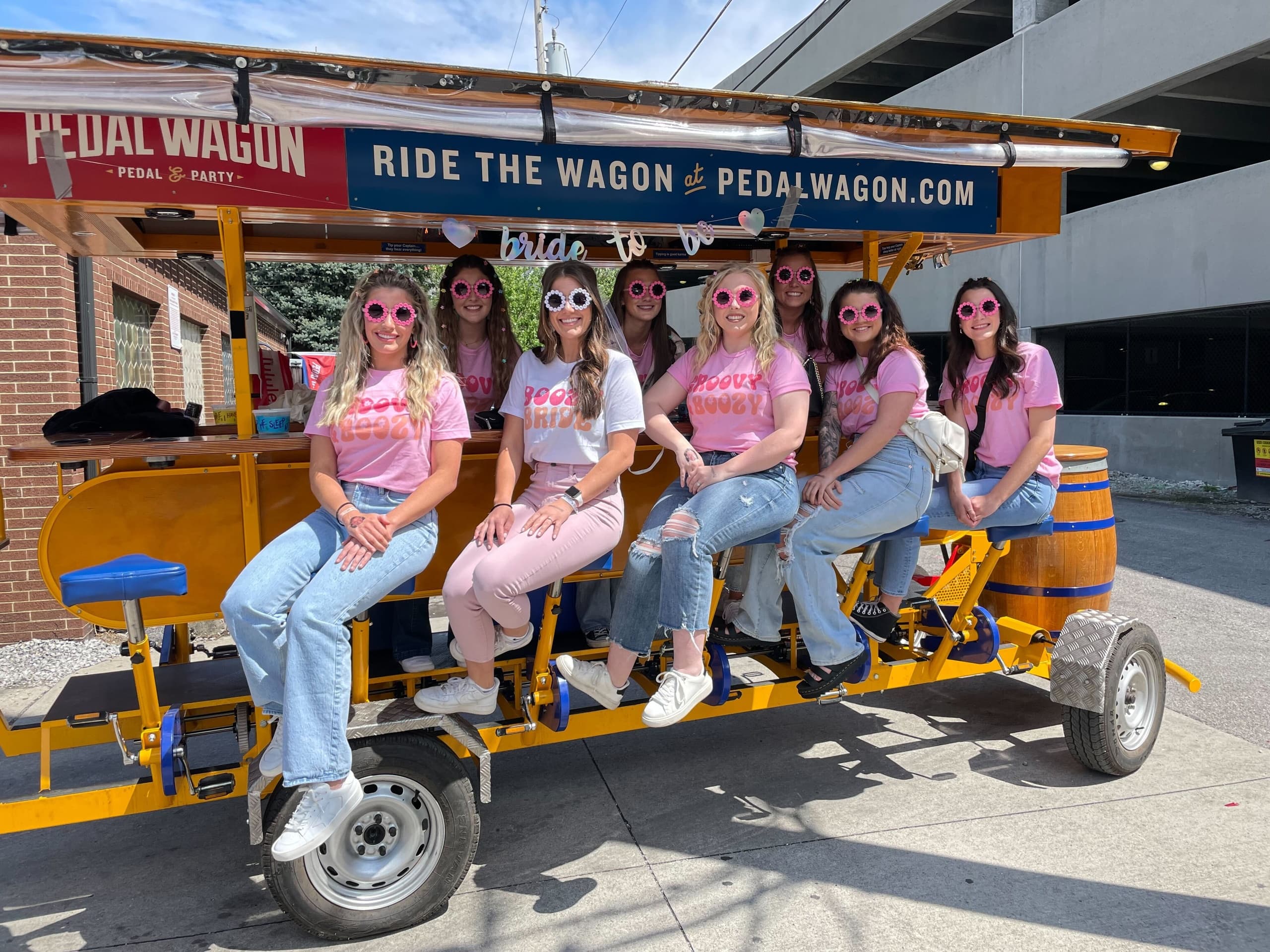 Bachelorette crew riding pedal wagon through Columbus district