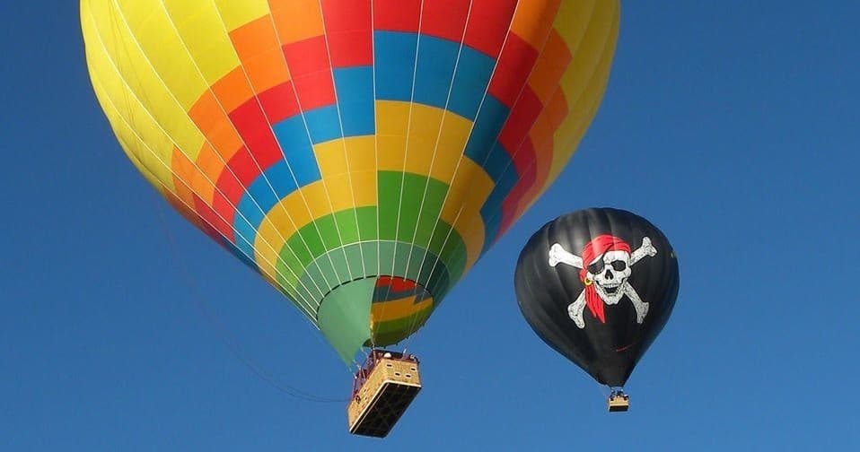 Colorful hot air balloons floating over clear blue sky festival