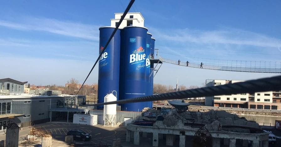 Riverfront Blue silos with pedestrian skywalk over canal