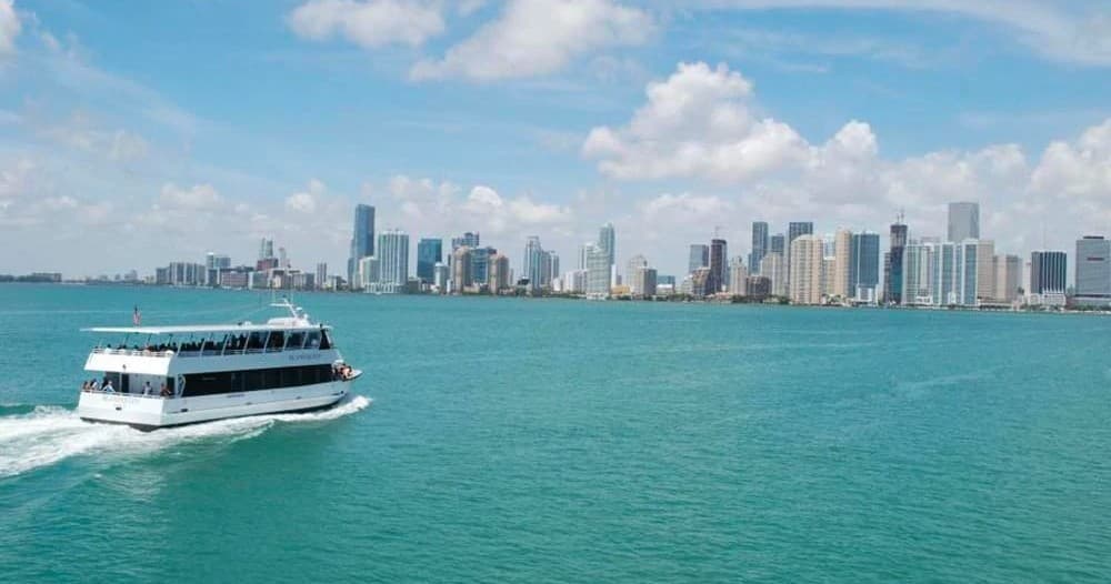 Sightseeing boat cruising near Miami skyline and Biscayne Bay