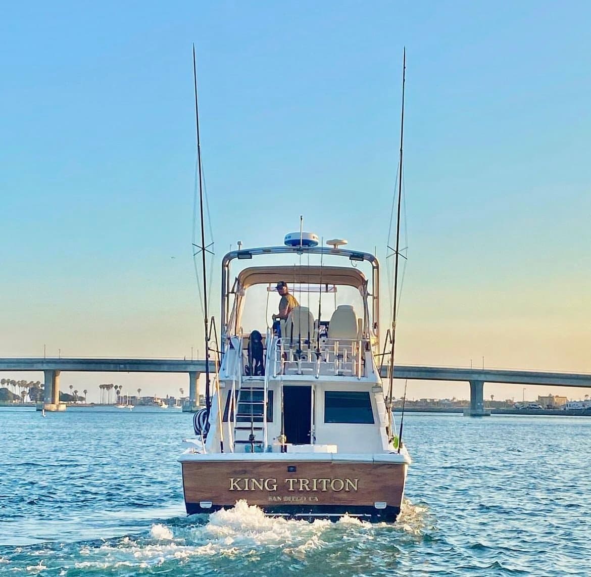 Sportfishing charter boat cruising San Diego harbor at sunset