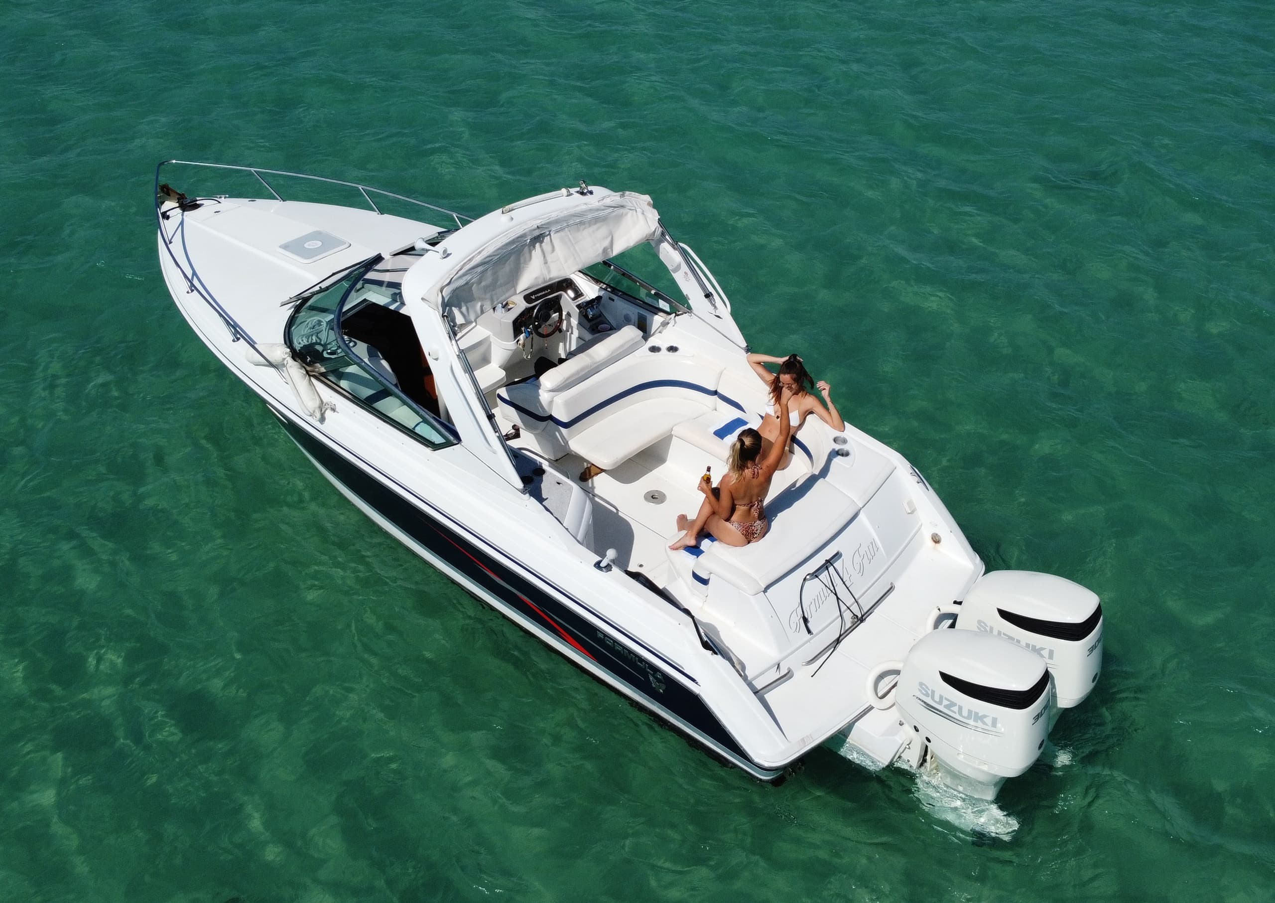 Aerial shot of luxury boat in Miami waters with sunbather lounging