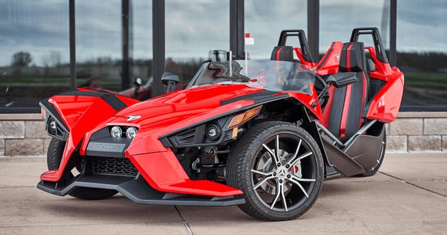 Red Polaris Slingshot rental parked outdoors for scenic road tours in Stonecrest