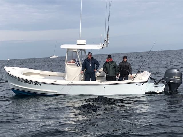 Fishing charter boat with crew on calm open ocean waters