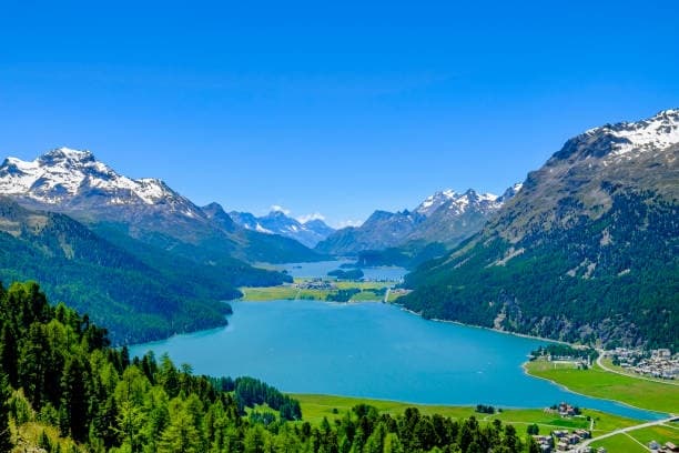 Crystal alpine lake framed by mountains and hiking trails