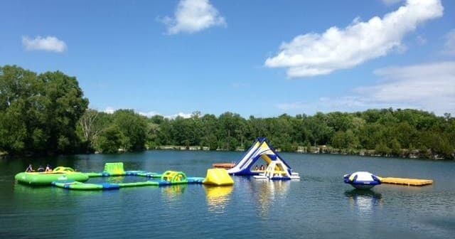 Wide view of inflatable obstacle course on Sheboygan quarry lake