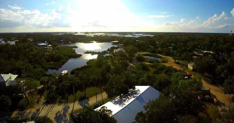 Aerial view of coastal marshes and waterways at sunset, scenic