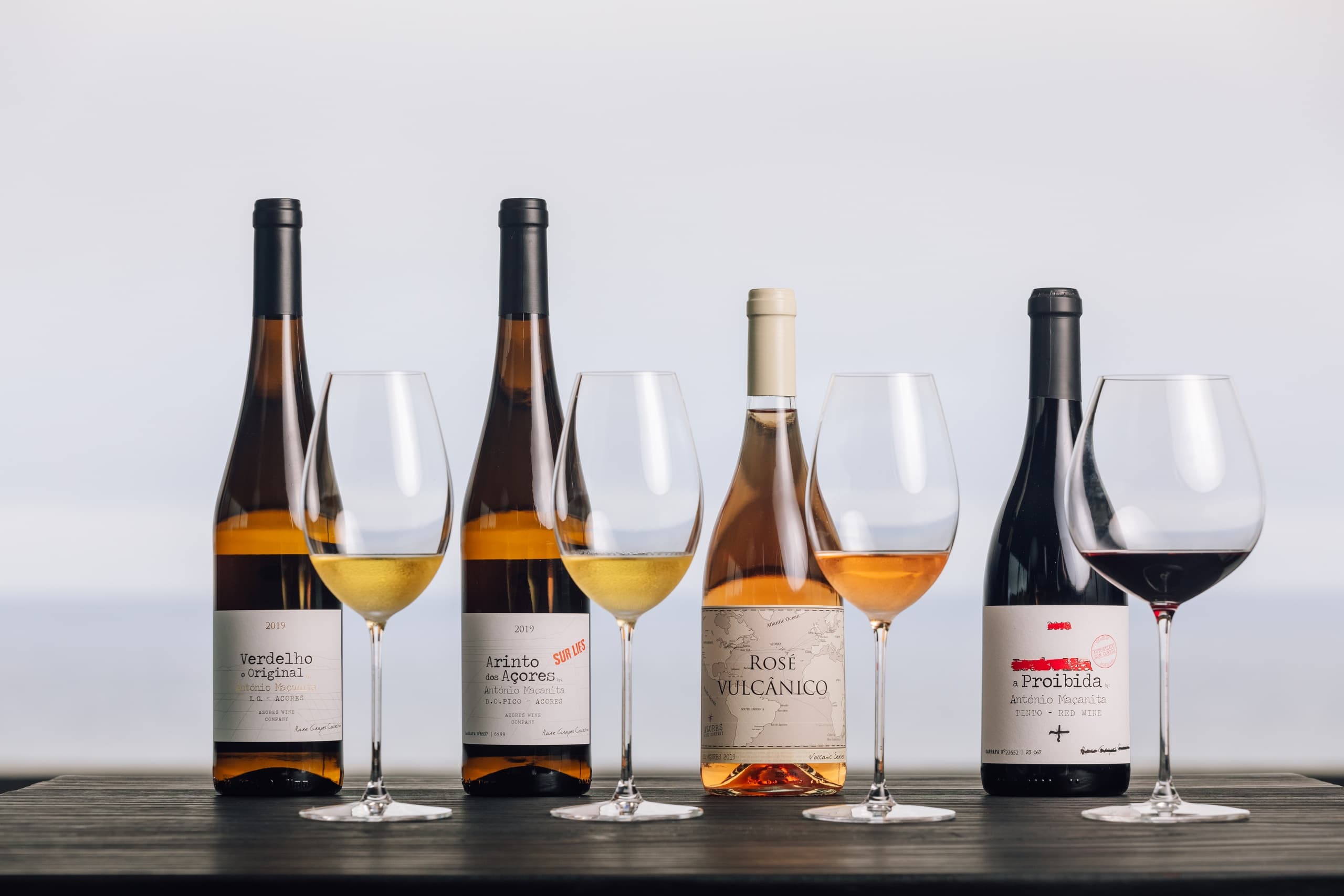 Assorted Azores wine bottles and glasses for tasting flight