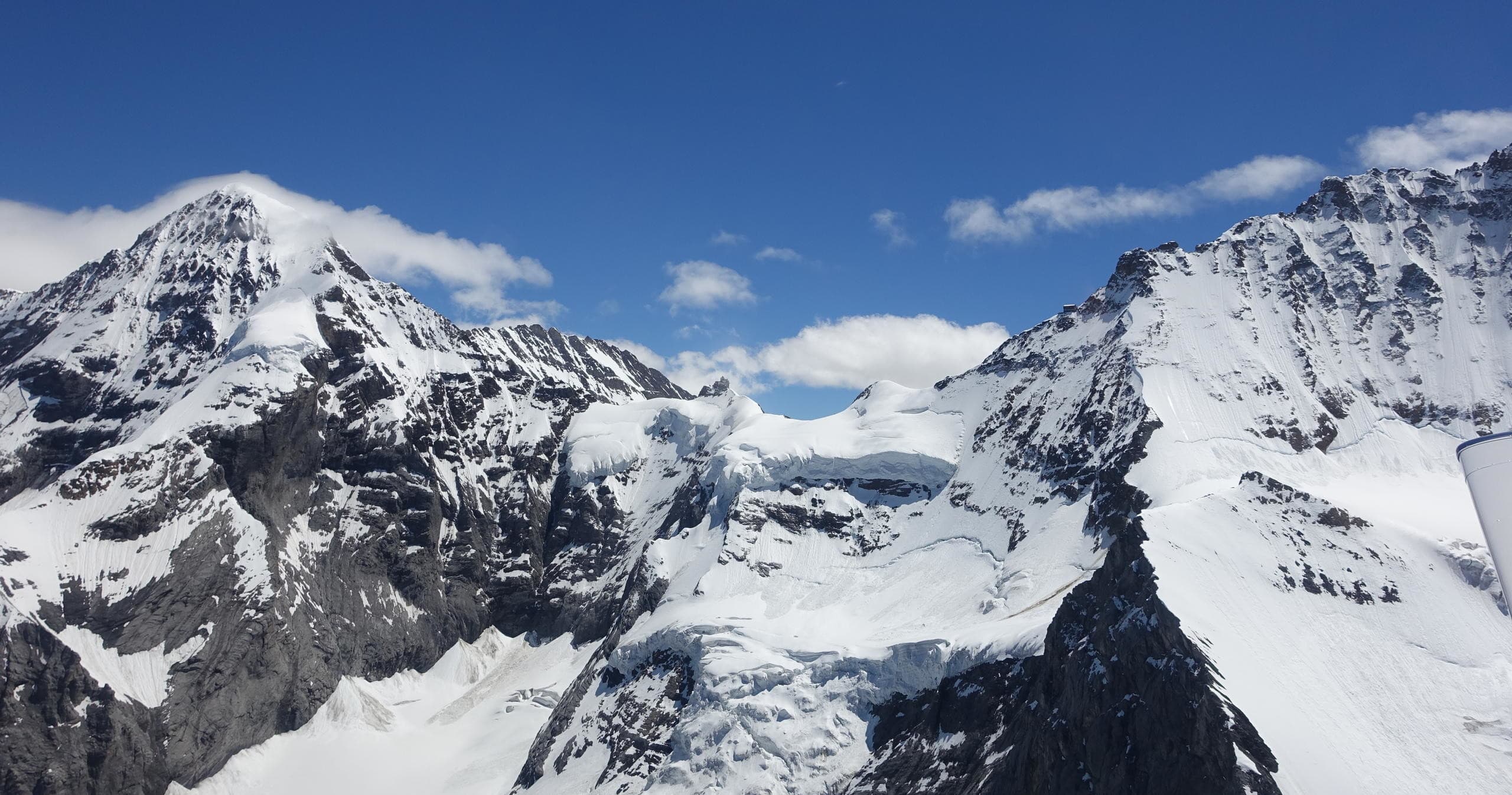 High alpine snow peaks and glaciers under deep blue sky