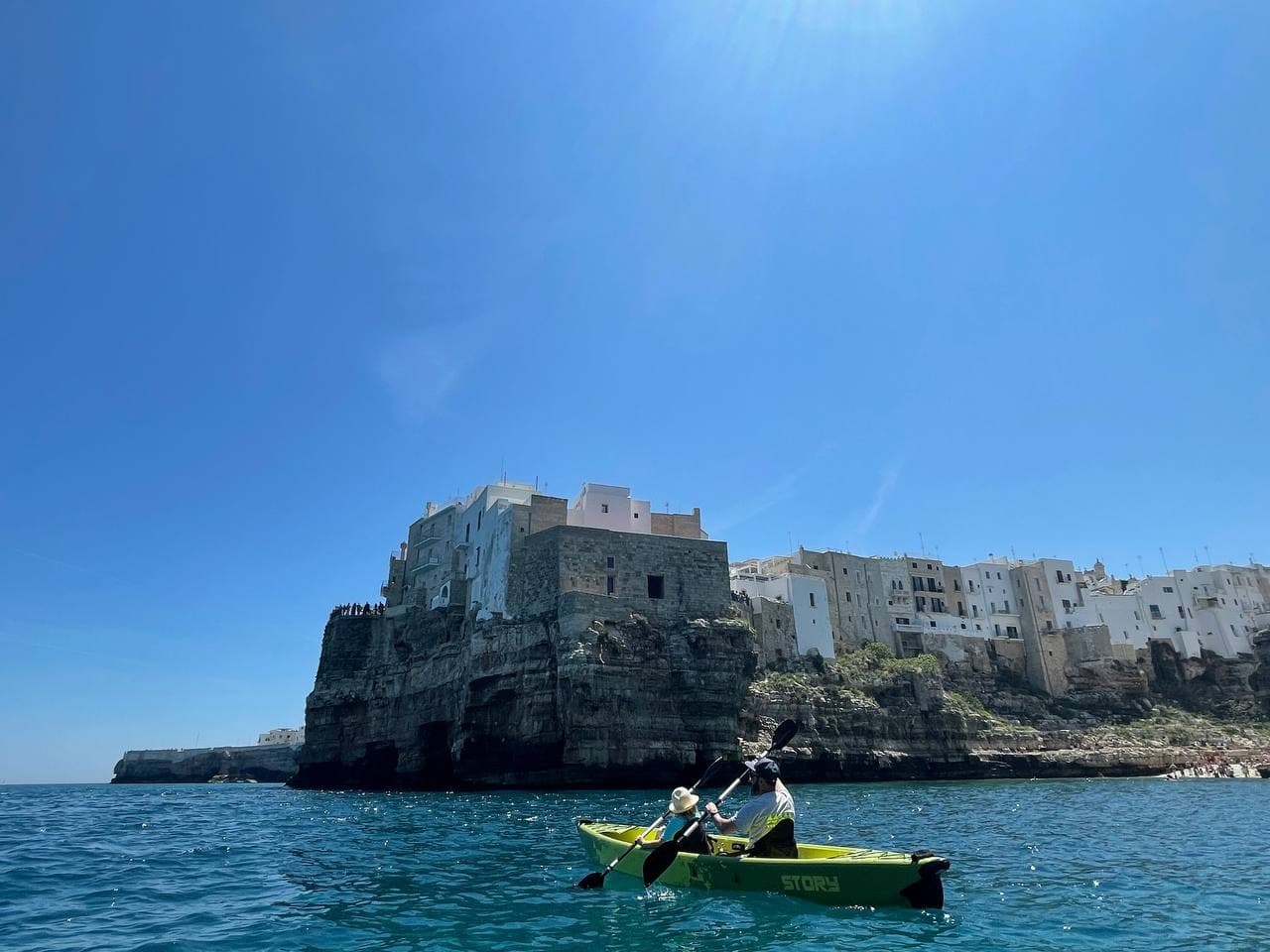 Kayakers paddling near coastal cliffs of Polignano a Mare
