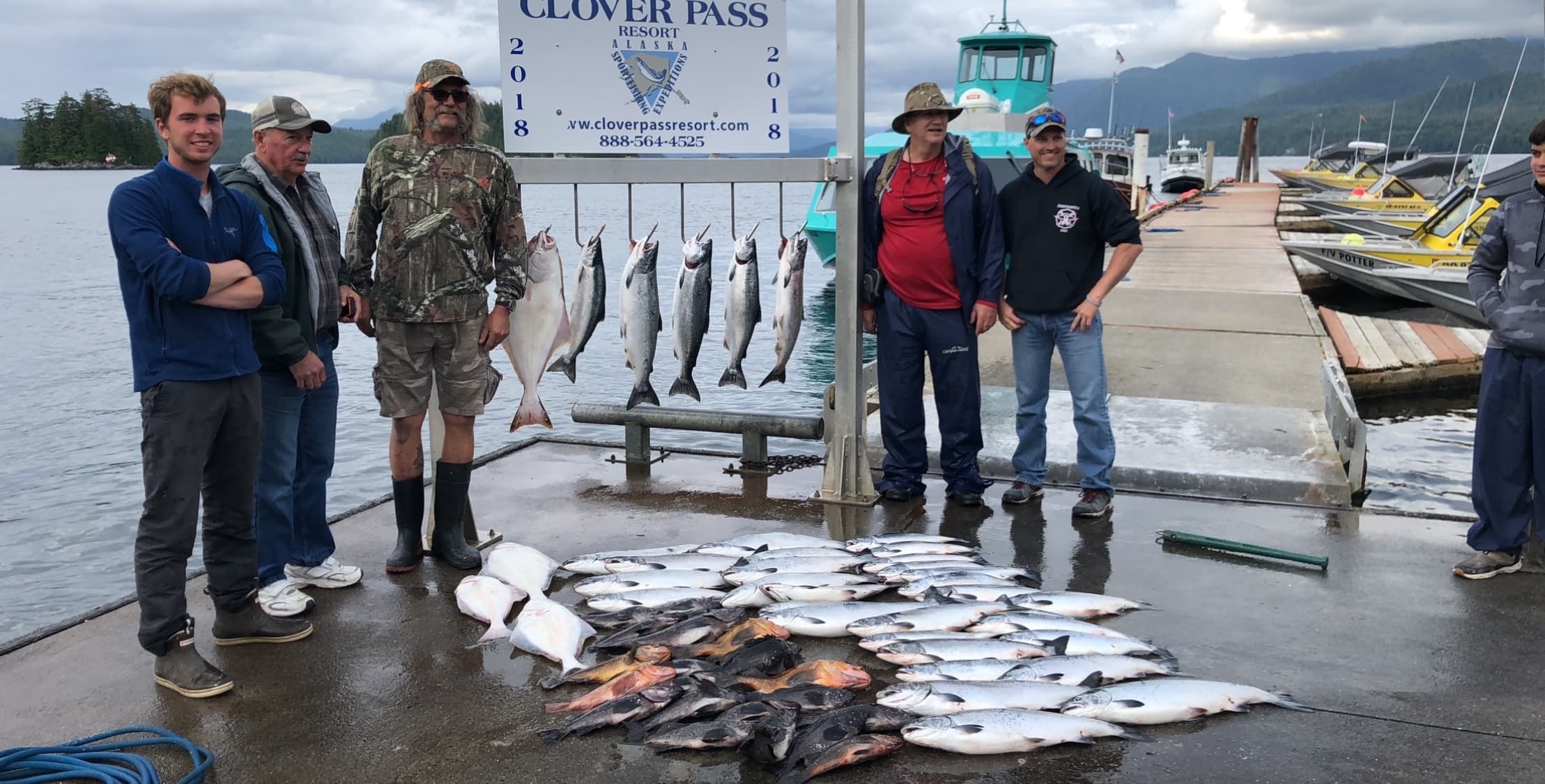 Fishing party showing mixed catch on Ketchikan harbor dock, Alaska