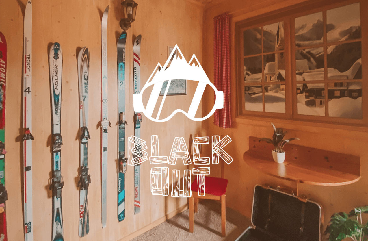 Skis mounted on wooden lodge wall, alpine gear display indoors