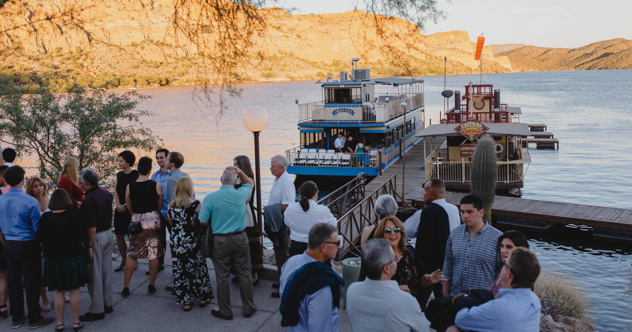 Passengers boarding Desert Belle at Saguaro Lake dock at sunset