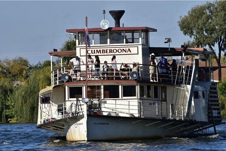 Front view of Cumberoona paddle steamer approaching on river, passengers