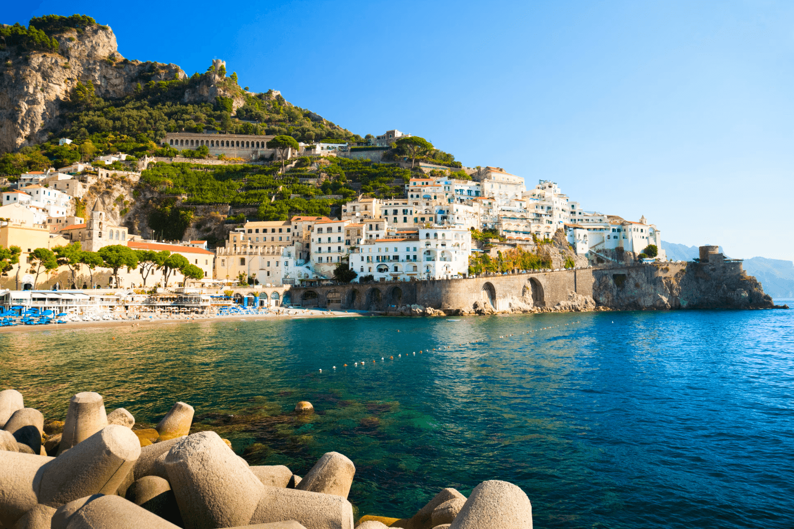 Coastal village panorama with breakwater and azure sea vistas
