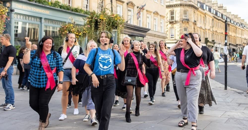 Group walking tour through historic Bath streets, city stroll