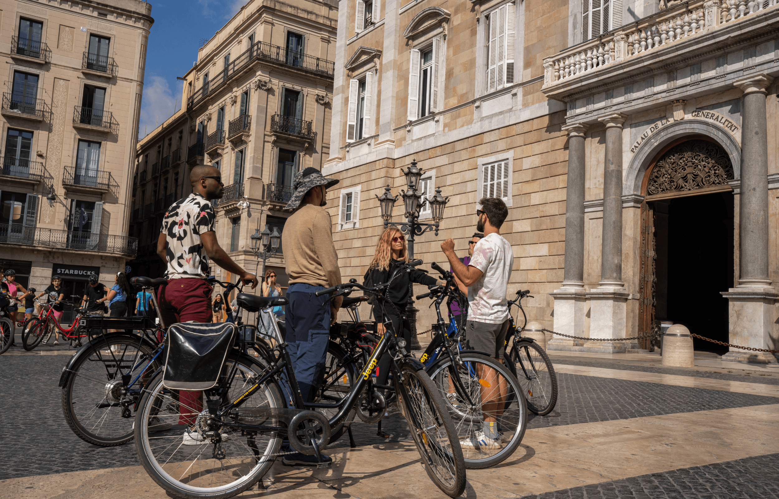 Cyclists touring historic city plaza with stone architecture
