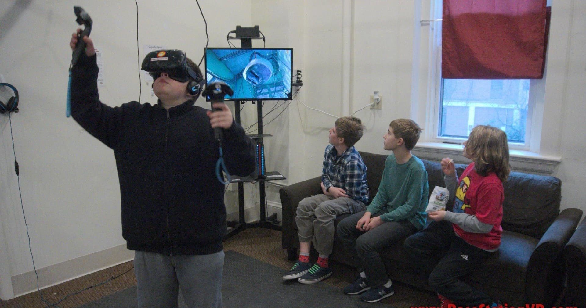 Group testing VR headsets in indoor gaming studio room