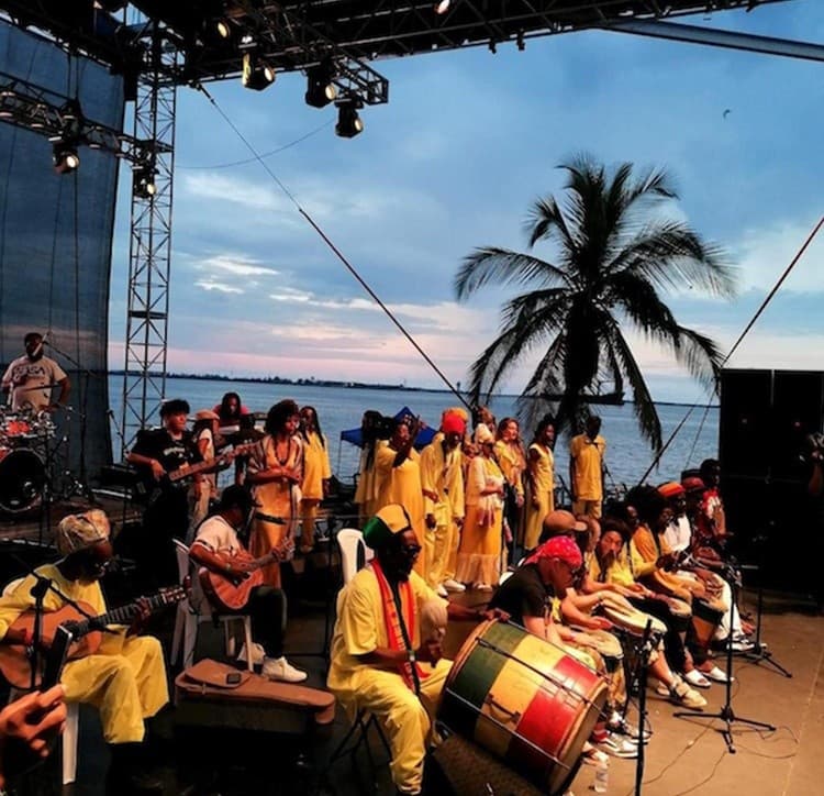 Sunset beach concert stage with palm trees and ocean view
