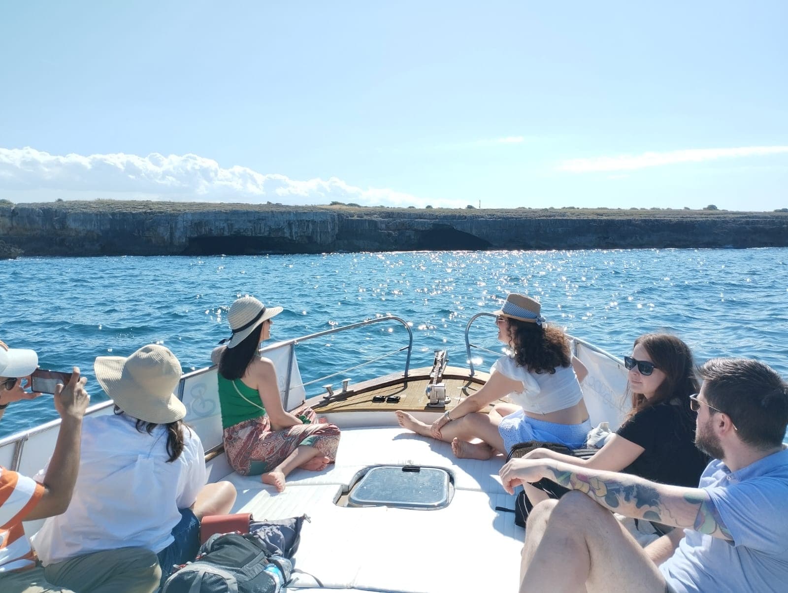 Group boat excursion enjoying coastal sightseeing and sun on deck