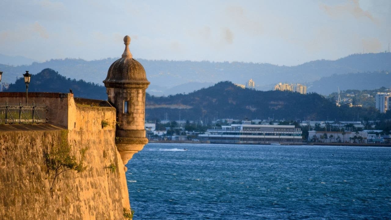 Historic garita sentry tower on stone fort above blue sea