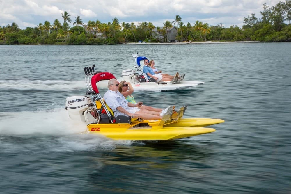 Yellow backwater skiff speeding past palms on Marco Island lagoon tour