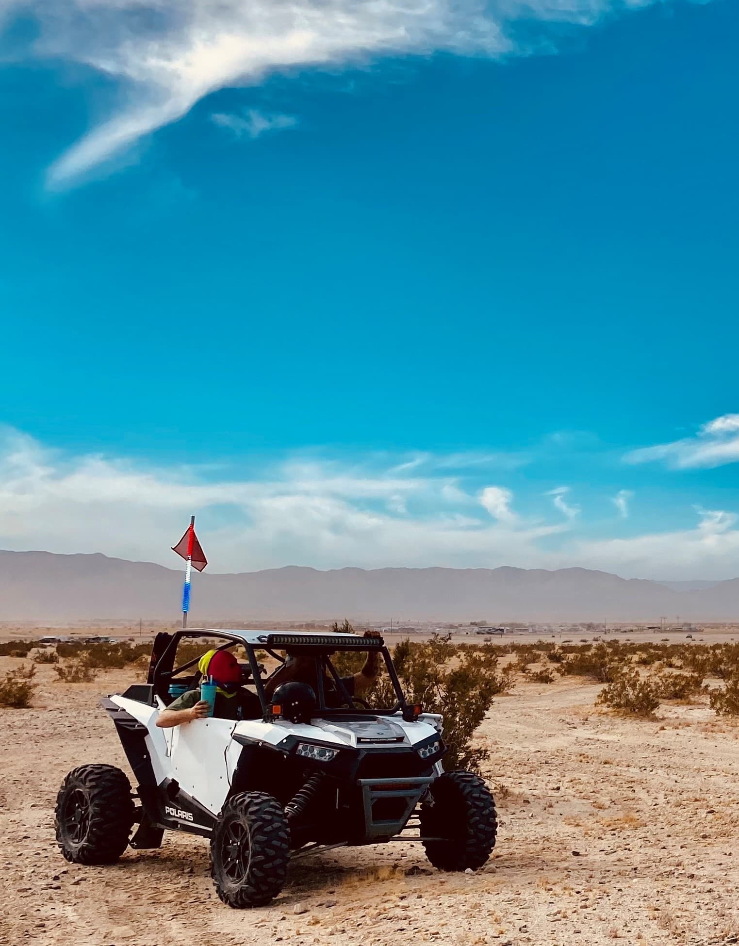 UTV off-road ride across Mojave-like desert with riders