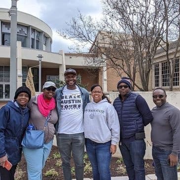Guided Black Austin walking tour group posing near UT campus