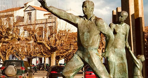 Bronze public sculpture in urban plaza depicting human figures