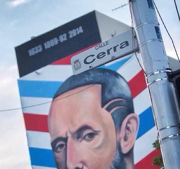 Outdoor mural portrait on urban street wall in San Juan