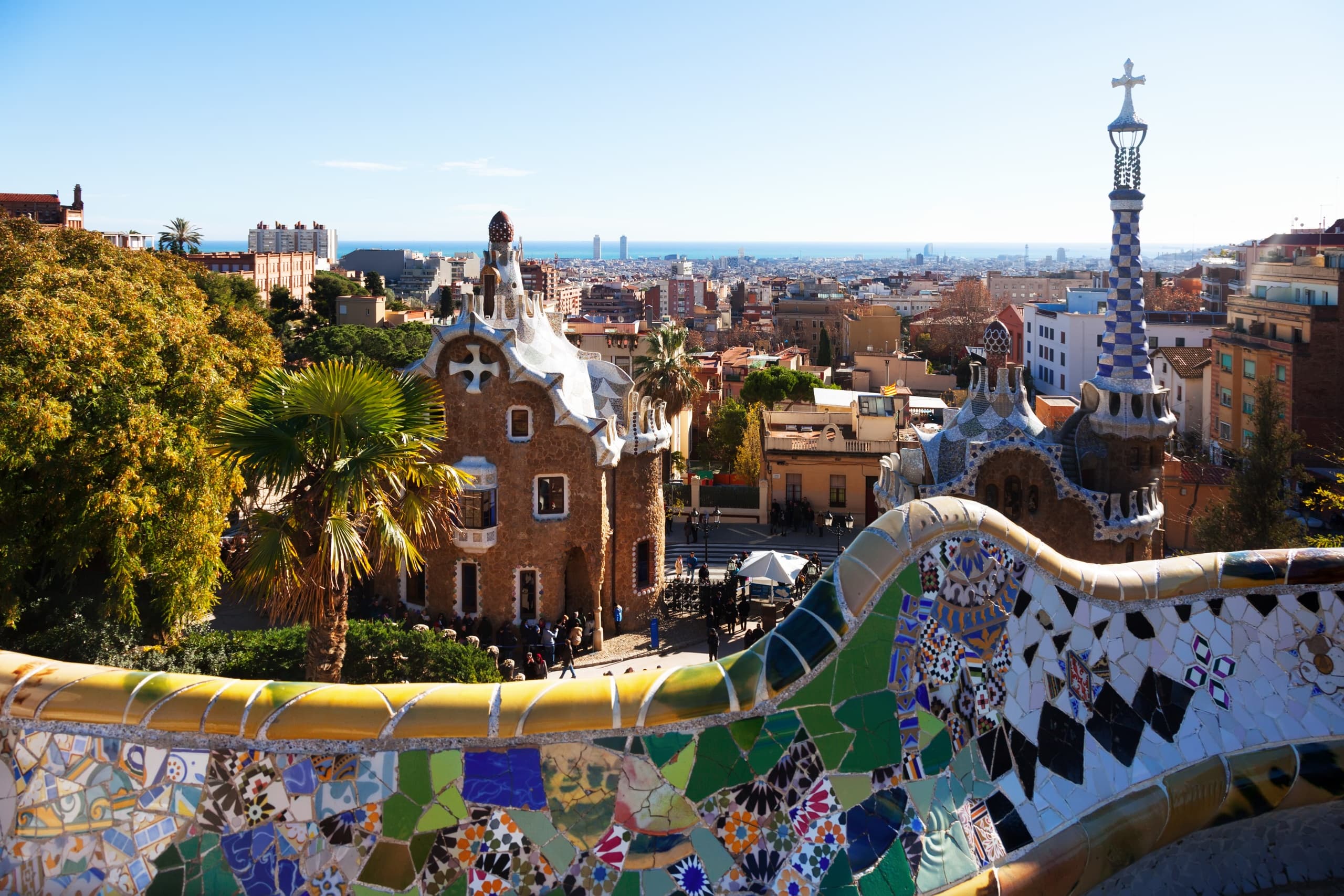 Strolling along Park Güell mosaic terrace overlooking Barcelona
