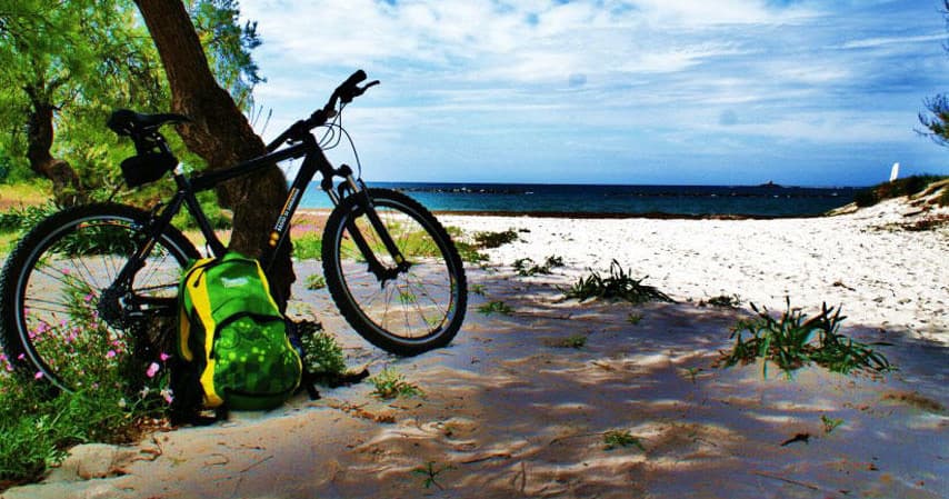 Mountain bike on sandy coastal beach, cycling adventure
