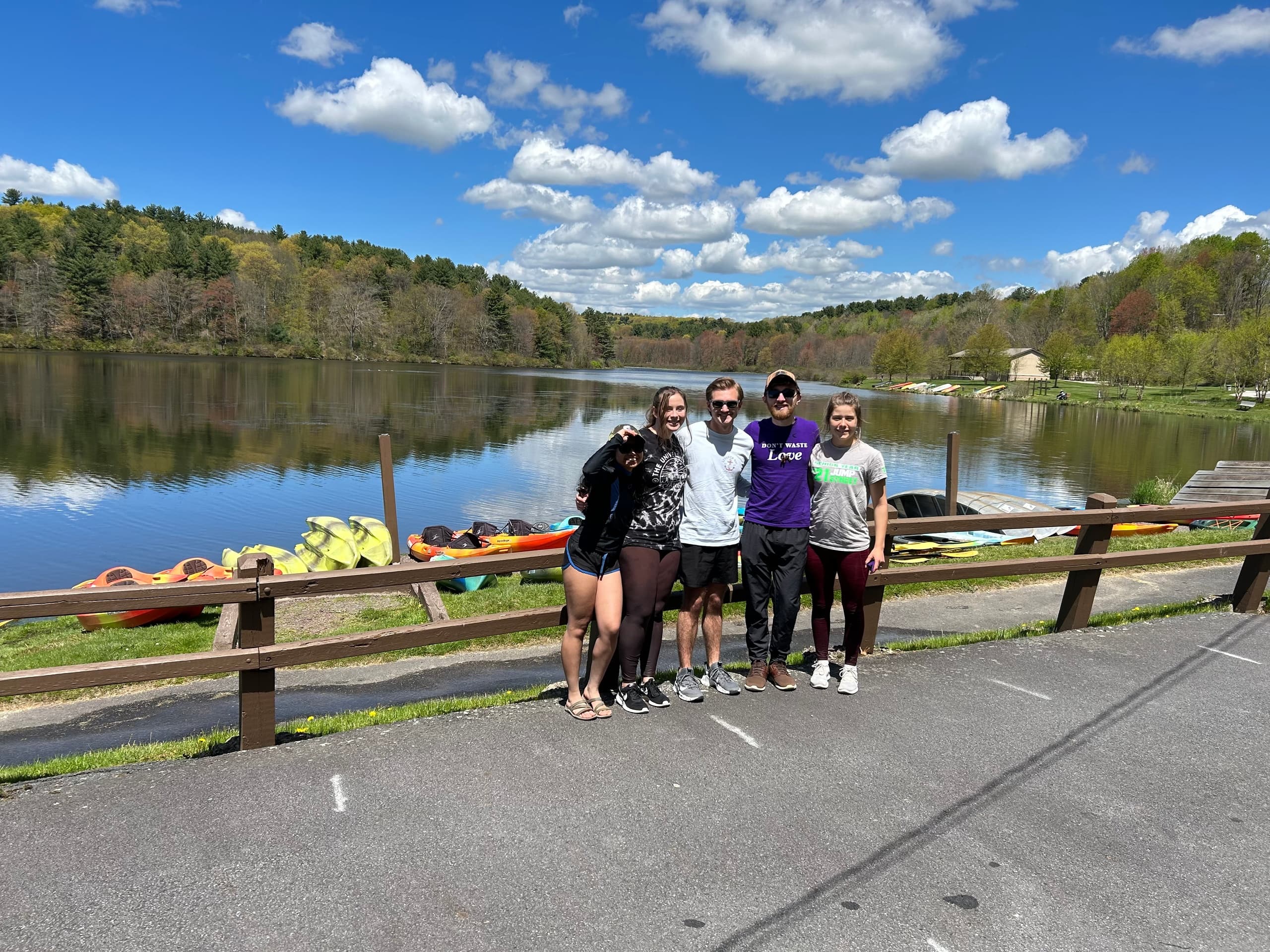 Group of paddlers at lakeside launch enjoying sunny day