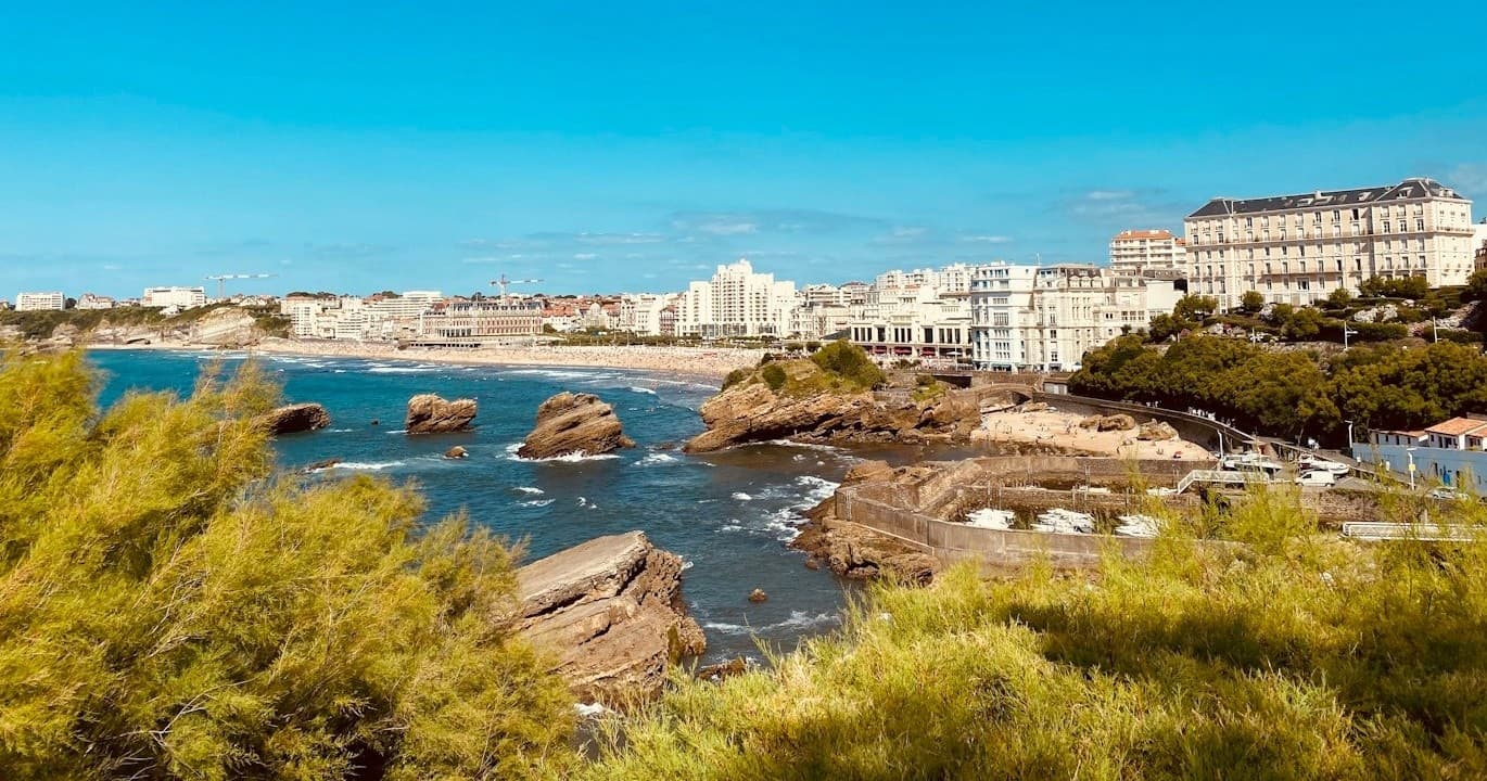 Rocky coastal shoreline with seaside town views, Basque Coastline