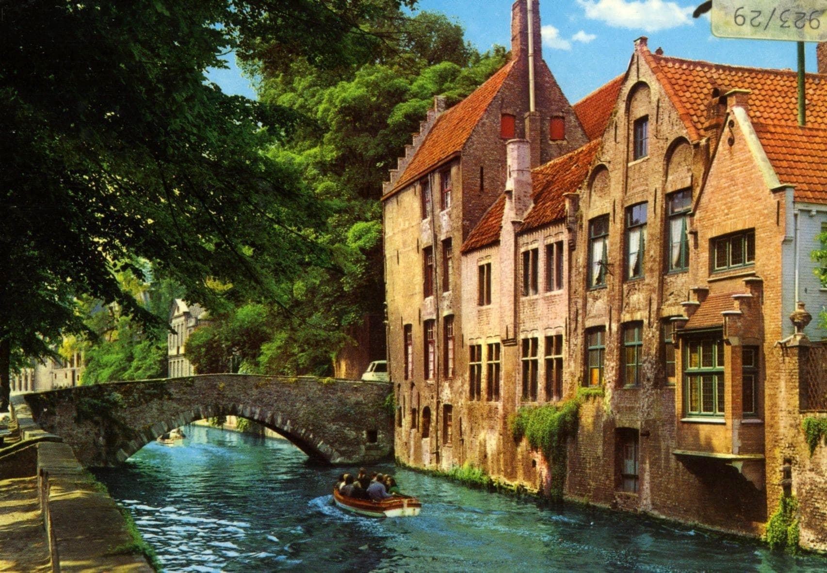 Scenic canal houses along Bruges canal, historic waterside view