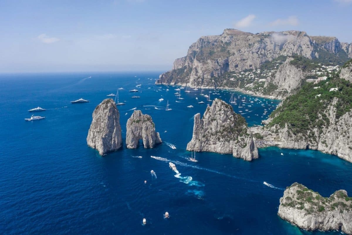 Boat tour past Capri's Faraglioni rock formations, open sea
