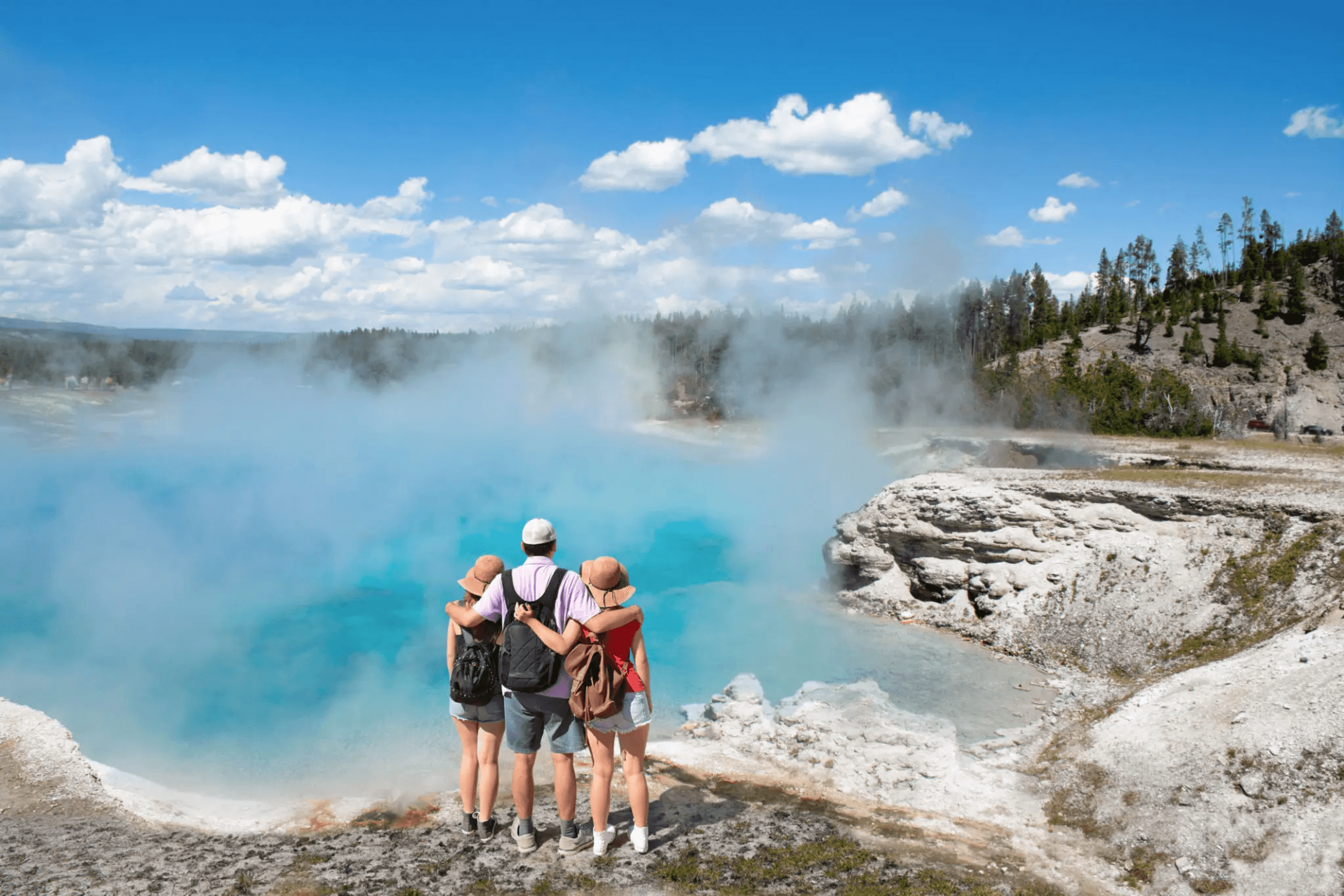 Tourists viewing colorful geothermal pool in Yellowstone National Park