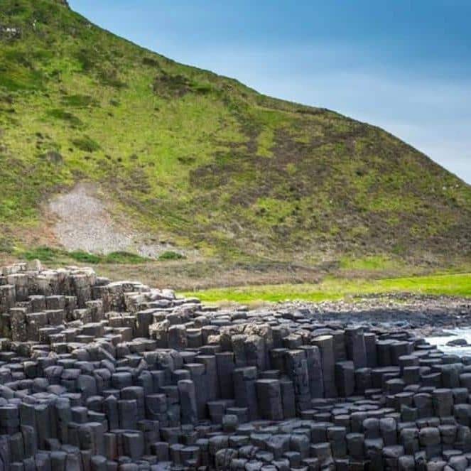 Exploring Giant's Causeway basalt columns on Northern Ireland coast