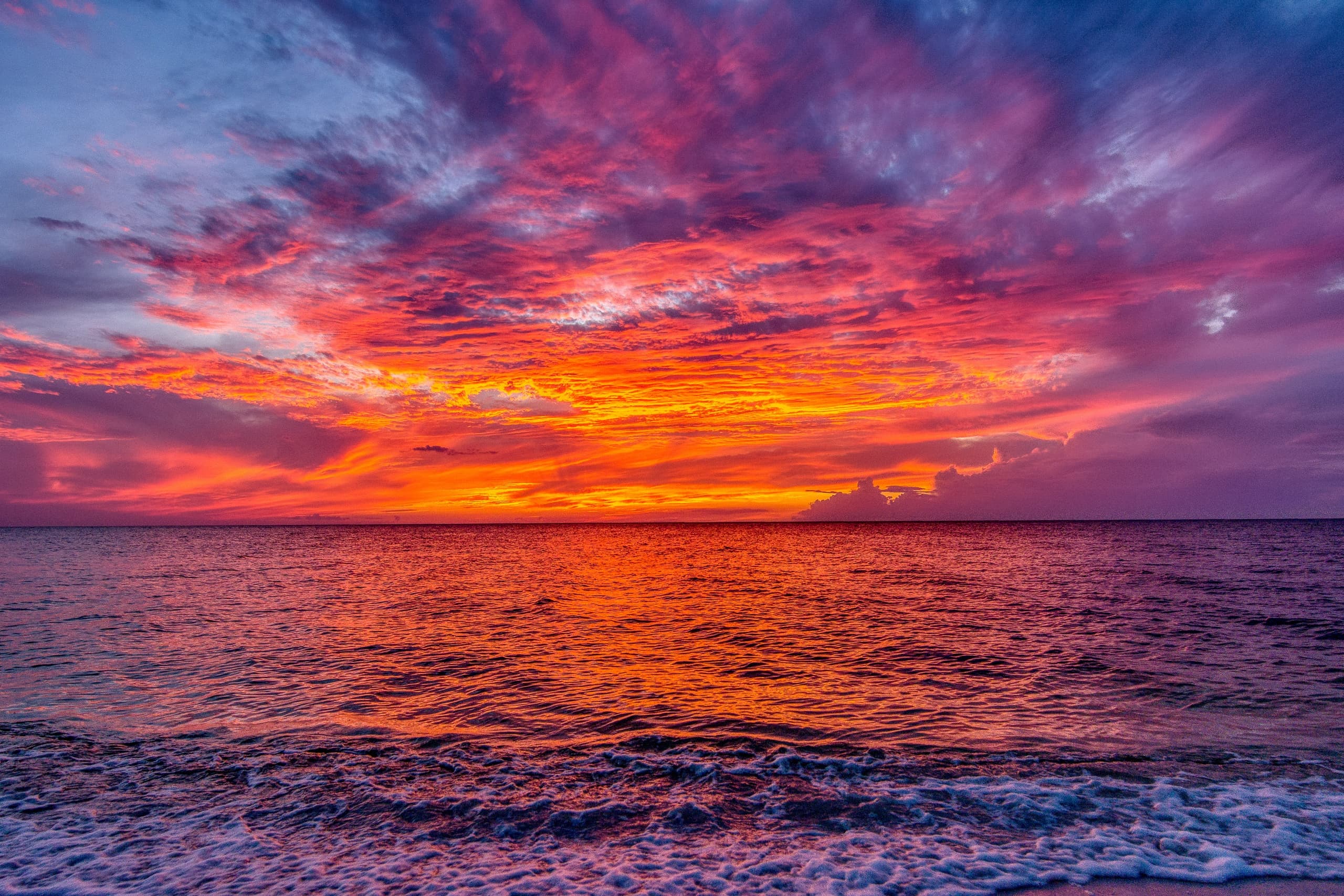 Vibrant sunset over open ocean with colorful dramatic sky