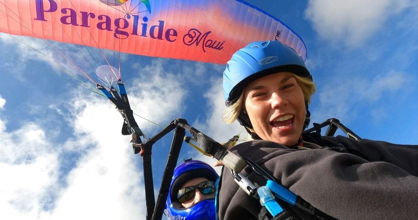 Tandem paragliding selfie over Maui coastline with smiling rider