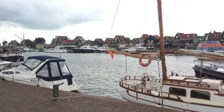 Harbor with moored sailboats and seaside village waterfront view